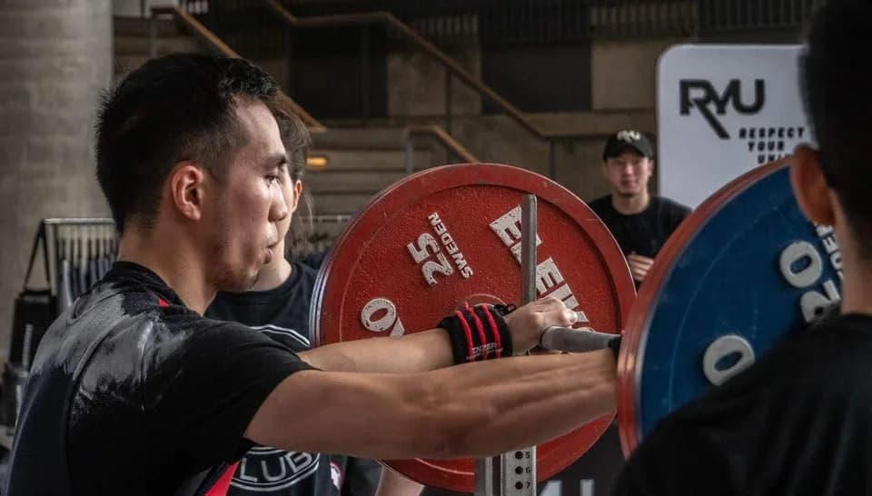 Eric preparing a barbell before a powerlifting attempt